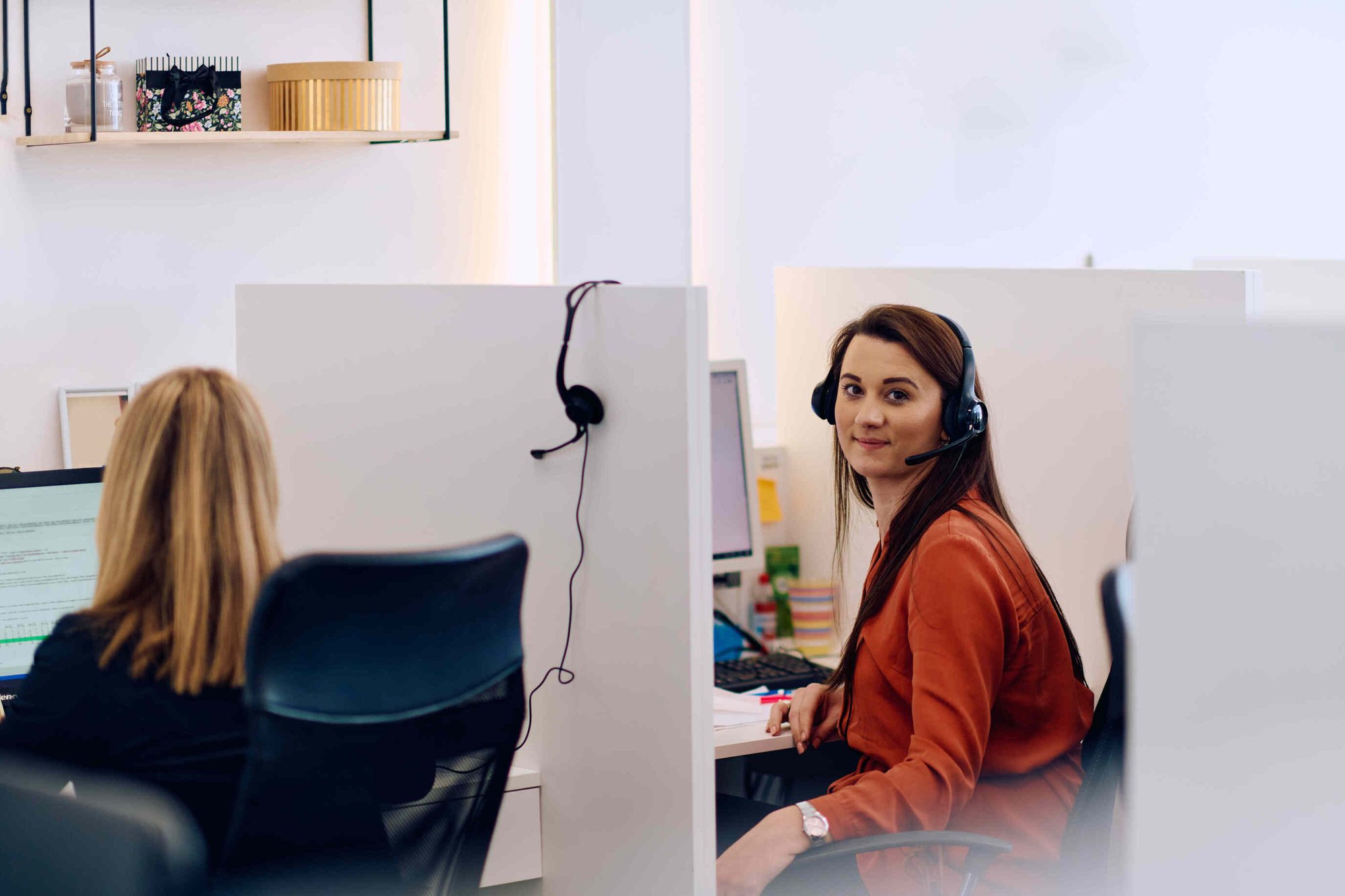 ACA support person on a call in her office