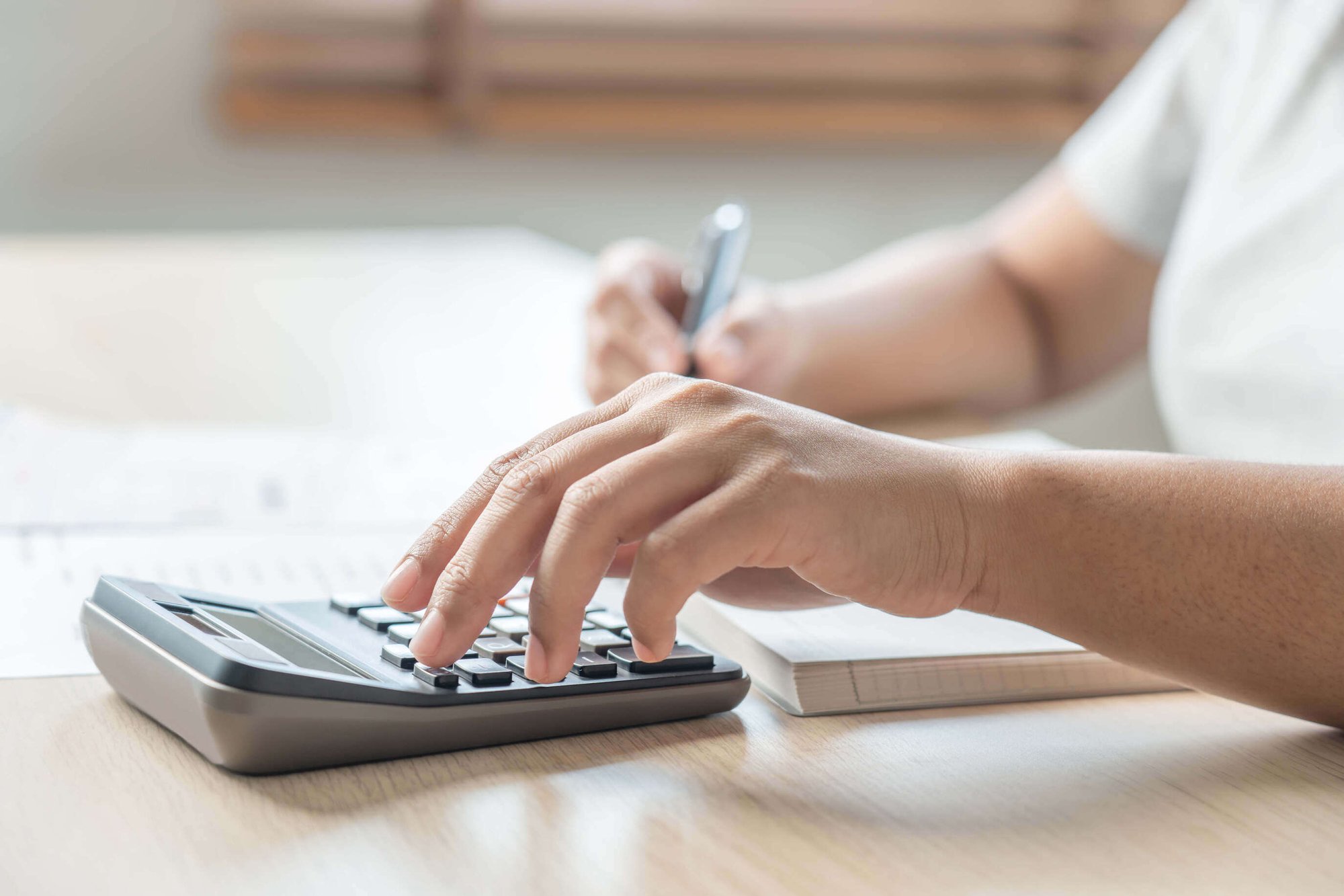 Benefit professional calculating ACA on a calculator