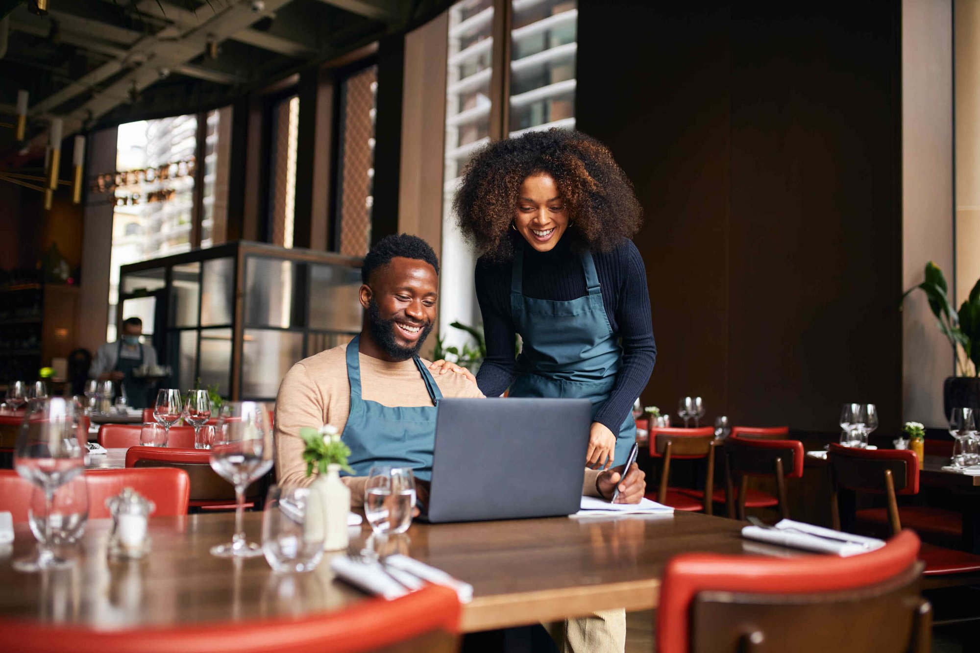 Restaurant workers looking at their ACA compliance